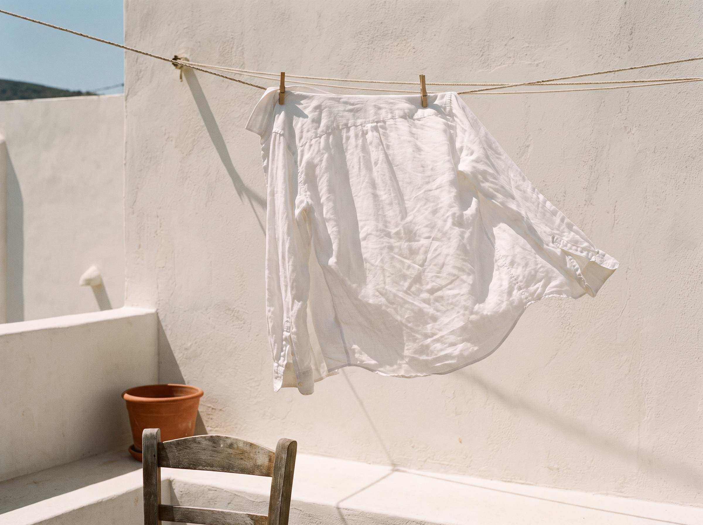 White linen garment drying on a terrace in the midday Mediterranean sun